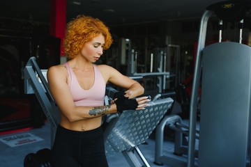 portrait of a sporty woman with red hair in the gym.