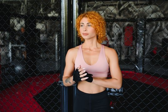 Woman boxer training fighter in gym. Concept mma sport.