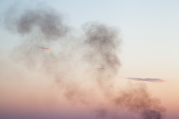 Black smoke from fire against the sky