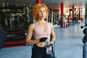 Close up image of attractive fit woman in gym