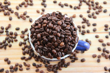 natural black coffee beans and ceramic blue a mug