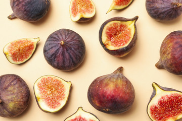 Fresh fig fruits and slices on beige background, top view