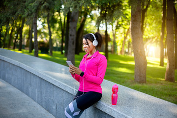 Black girl jogger using sport app for smartphone