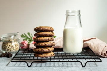 Oatmeal chocolate cookies with milk.