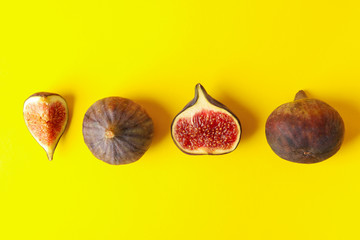 Flat lay with fig fruits on yellow background