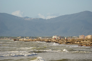 Fototapeta na wymiar Italy Tuscany Maremma, on the beach towards Bocca di Ombrone, view of the coast line, in the background Marina di Grosseto, period of strong storm