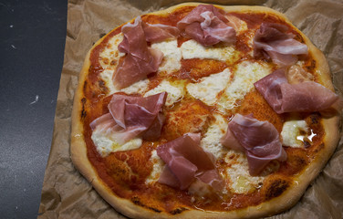 Homemade pizza with parma ham and mozzarella.