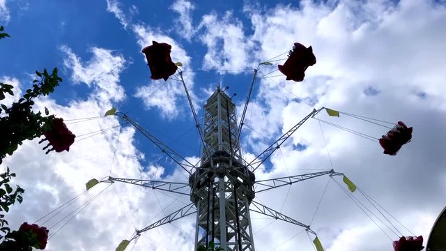 the ride is spinning at the top of the outdoor amusement Park