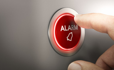 Man pressing a red security alarm button.