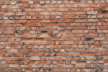 Fototapeta premium Wall of red bricks. Texture or background of bricks.