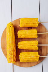 Boiled corn on a white wooden natural background