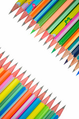 Couple of row of different colored wood pencil crayons facing each other on white paper