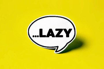 LAZY speech bubble on white paper isolated on yellow paper background with drop shadow. COPY SPACE.