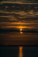 Lighthouse in the sunset and the moon rise