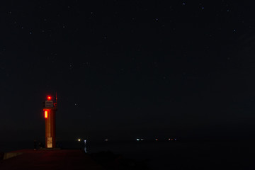 Lighthouse in the sunset and the moon rise