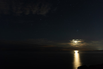Lighthouse in the sunset and the moon rise