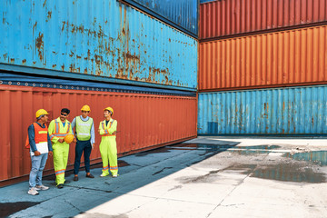 group of foreman relaxing and talking in breaking time at cargo container site