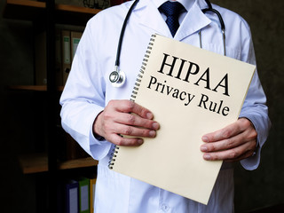The doctor shows HIPAA privacy rule in his office.