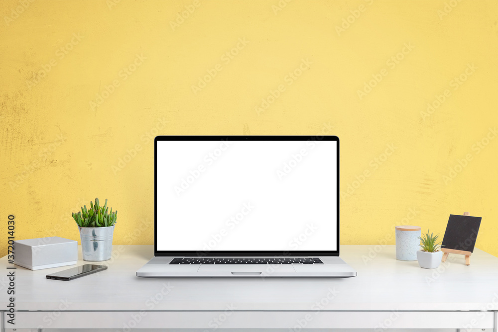 Aufkleber laptop computer mockup on office desk with yellow wall in background. isolated screen in white for w
