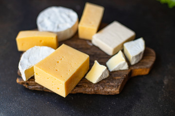 cheese assortment of different types of hard and soft cheeses serving portion size raw natural product top view copy space text space