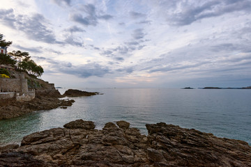 sunset at Saint-Enogat beach and rocks in Dinard in Brittany, France