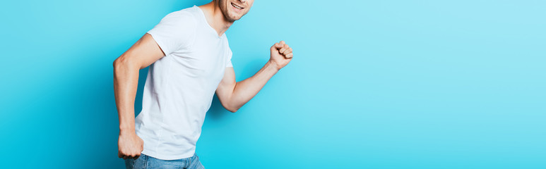 Panoramic crop of man in white t-shirt on blue background