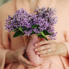 woman hands with lilac flowers