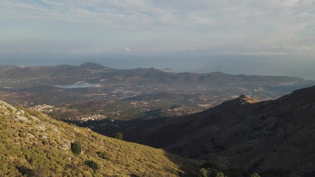 Aerial view of the villages of Speloncato and Ville di Paraso in the Balagne region of Corsica with the Regino valley and Mediterranean coast in the distance