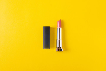 female bright lipsticks on mono colour yellow background