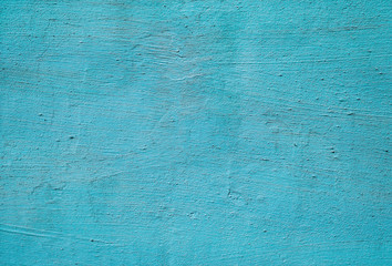 Texture of thick old blue paint on a plastered wall. Colored surface background.