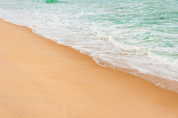 Texture of sand and sea water after breaking a wave separated by a diagonal