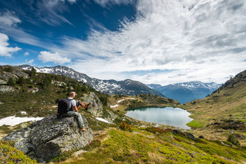 Fototapeta na wymiar Adventure Couple Man and Dog Trekking Outdoors in High Andorra Alps Mounitains