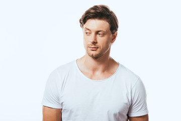 Obraz premium Confident man in white t-shirt looking away isolated on white