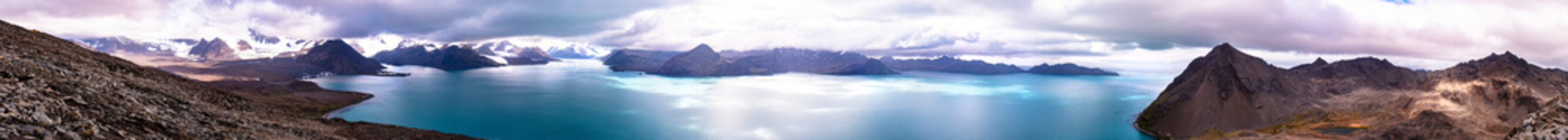 Naklejka na ściany i meble Wide panorama of the beautiful landscape with mountains, sea, and clouds..