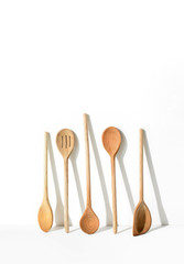 Kitchen utensils casting a strong shadow on a white wall, minimalist contemporary  home kitchen decor concept