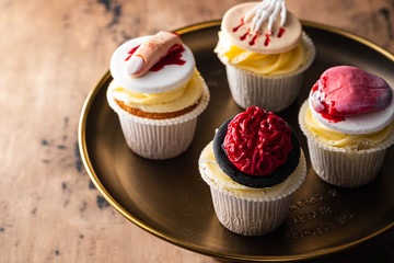 Halloween cupcakes with variety of spooky decorations.