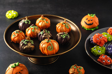 Halloween gourmet cake pops with black background. Autumn concept. Halloween holiday.
