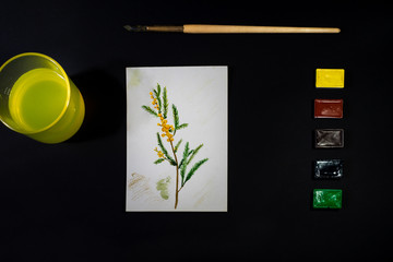 Colour model of a drawing. Watercolour paints on black background. Brushes, colours. and album for creativity. Back to school. The life of a paint artist. Bright creativity to inspire for drawing. 