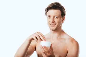 Shirtless man holding cosmetic cream and looking at camera isolated on white