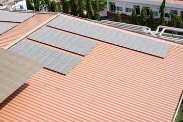 Solar cell panel installed over the rooftop of the building against sunny day