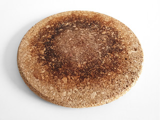 Aerial view of round heat resistant bamboo mat, surface protector. Kitchen and household utensil close up.