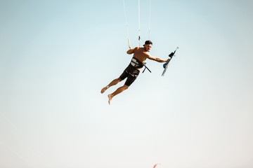 Fototapeta na wymiar Kitesurfing Kiteboarding action photos man among waves quickly goes