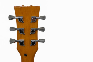 View of back of a guitar neck with six chrome tuners