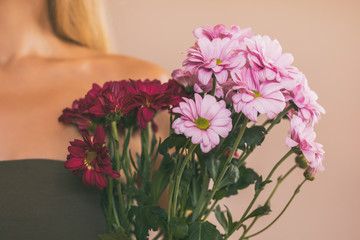 Woman holding beautiful bouquet of flowers.Focus on flowers.
