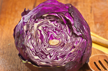 top view, close up of a head of red cabbage with top sliced off reveling a patter of purple and...