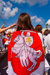 Vitebsk, Belarus - August 16, 2020 : a girl with national flag of the state of belarus with a coat...