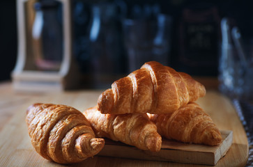 Croissants stacking on wooden board