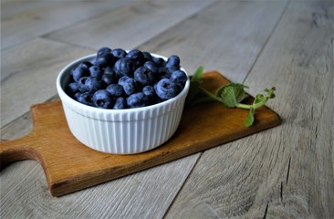 
a plate with ripe berries on a board