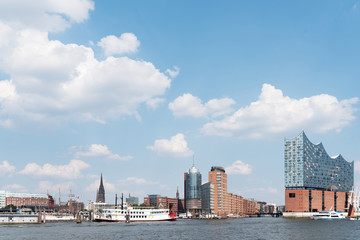 Obraz premium Hamburg cityscape with Elbe River, waterfront and concert hall against beautiful blue summer sky