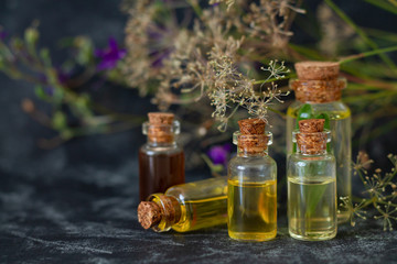 Herbal essential oils in glass bottles. Aromatherapy, spa, massage, skin care and alternative medicine concept